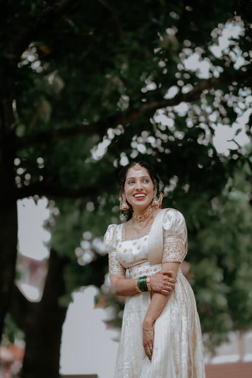 A beautiful woman in a white dress posing for a photo