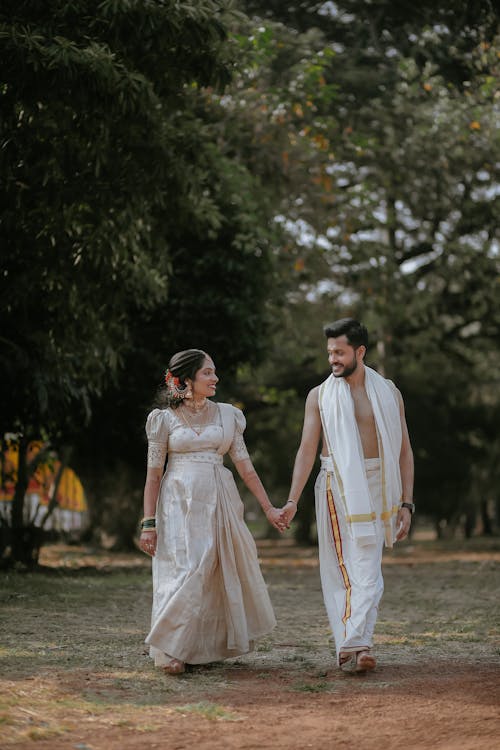 Smiling Couple Walking Together in Traditional Clothing