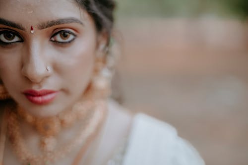 Close-up Photo of a Bride in Traditional Clothing, Jewelry and Makeup 