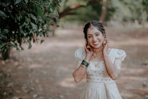 A beautiful indian woman in white dress posing for the camera