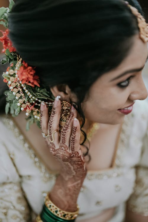 A beautiful indian bride with her hands on her head