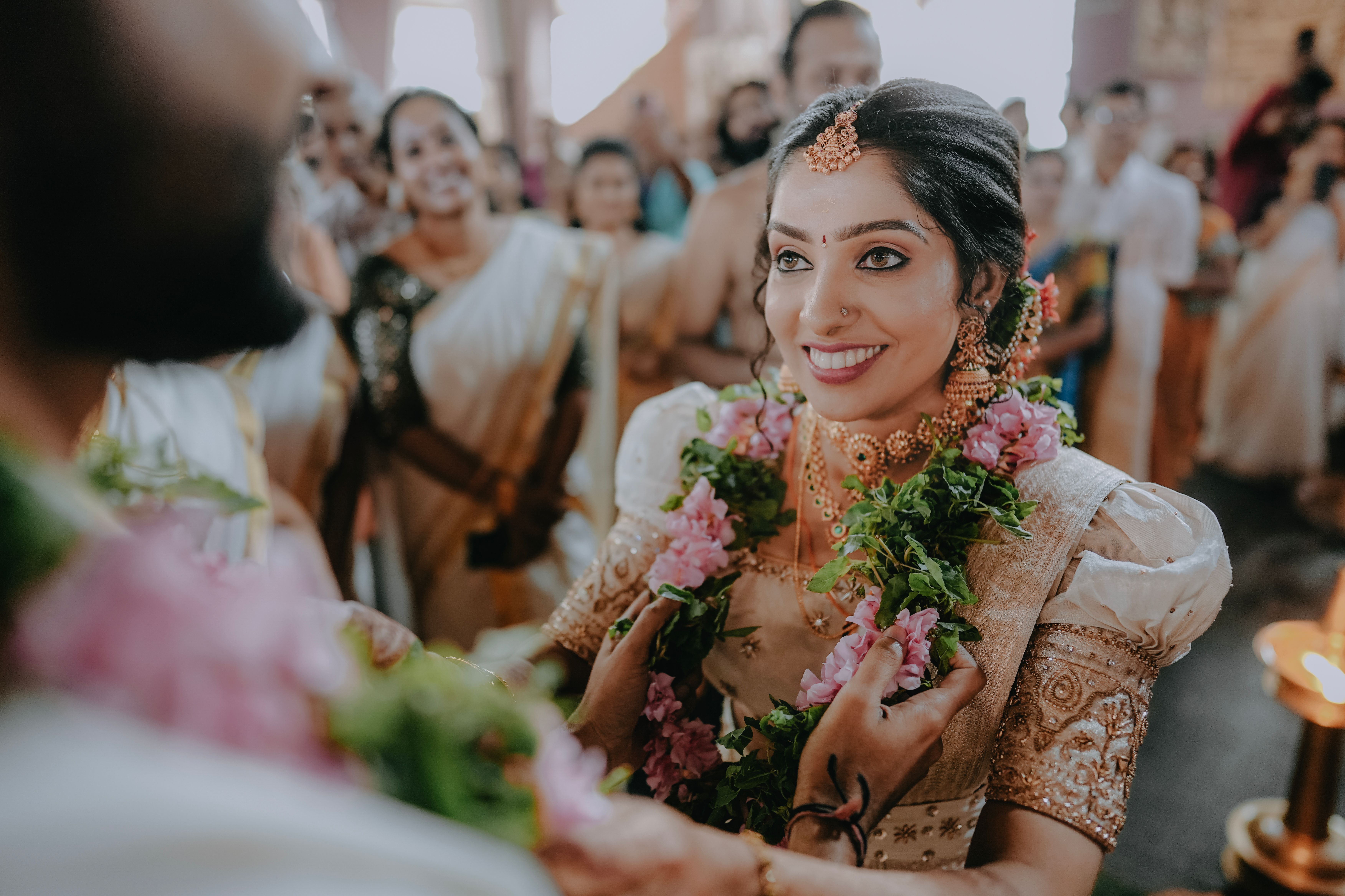Bride During a Traditional Indian Ceremony with Guests in the Background 