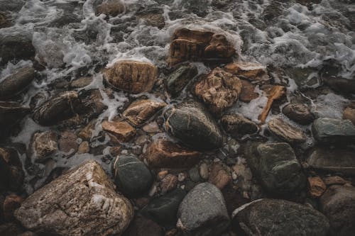 A photo of rocks and water on a beach