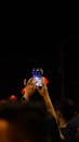 Person Hands Holding Smartphone and Recording Concert