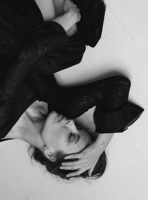 Woman Lying Down with Eyes Closed in Black and White