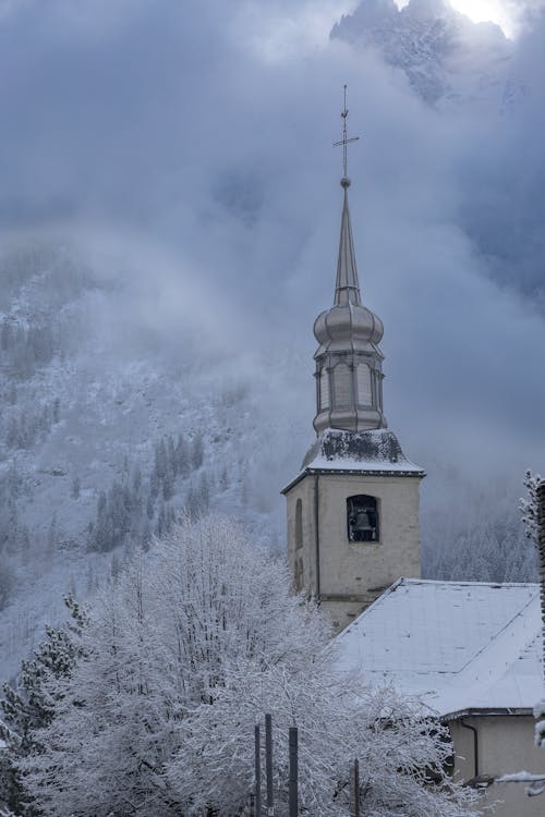 A church with a steeple in the snow