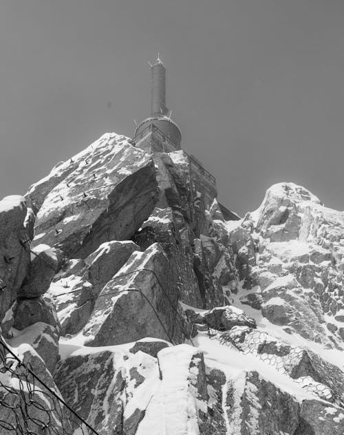 A black and white photo of a mountain with snow on top