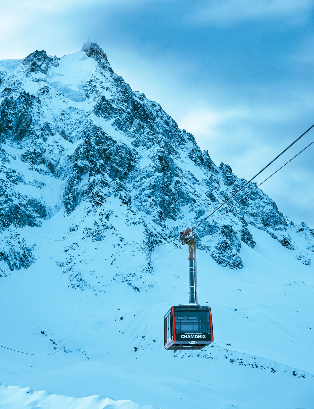 The red Chamonix cable car against snow-plastered crags