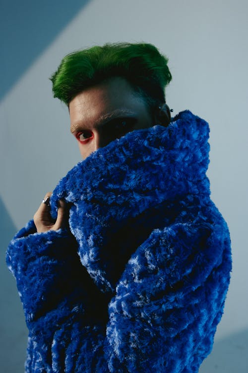 Modern Studio Shot of a Model with Green Hair Wearing a Blue Coat