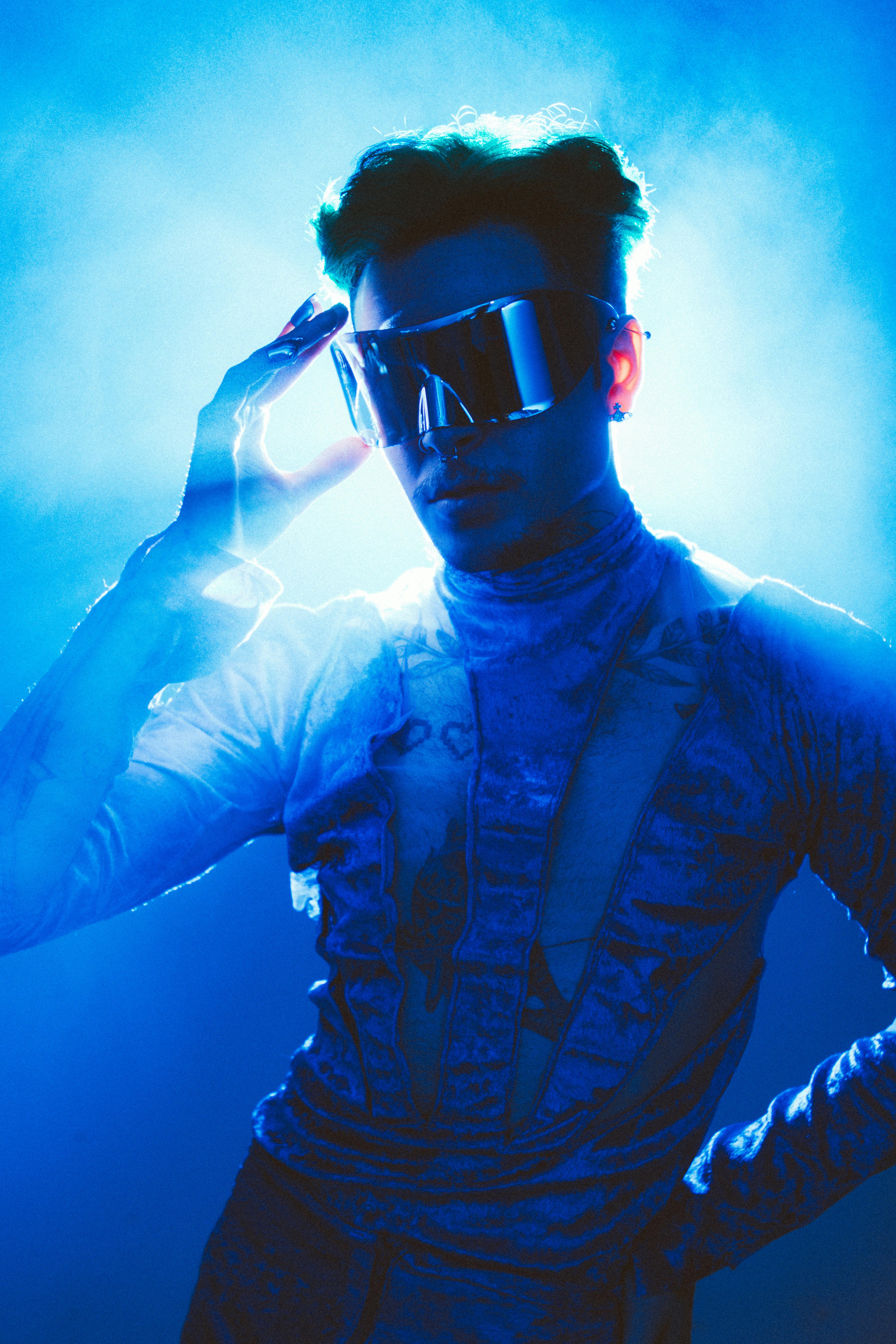 modern studio shot of a model in a costume and glasses