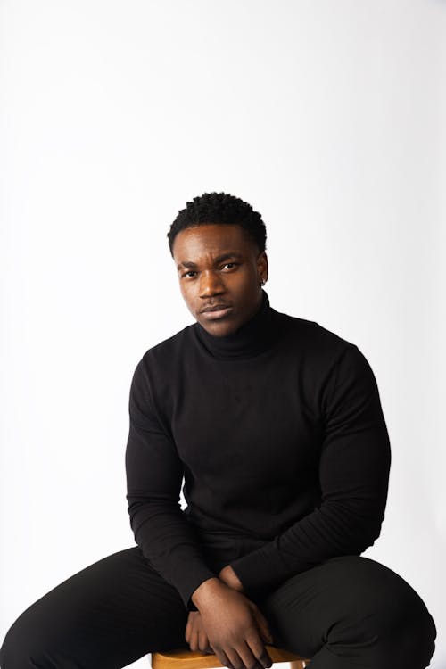 Studio Shoot of a Man Wearing Black Clothes, Posing against a White Background