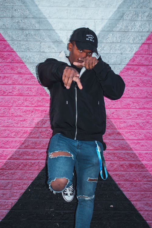 Man Leaning on Pink and Gray Wall