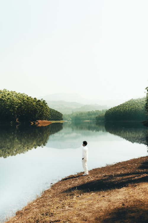 A person standing in front of a lake