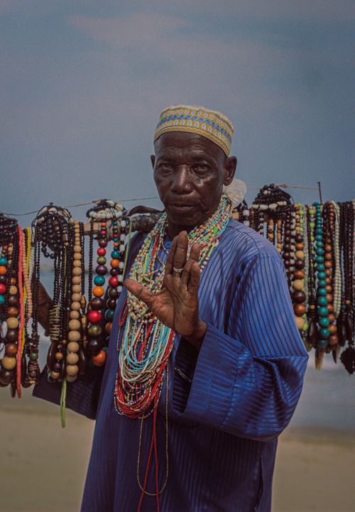 Free Portrait of an African man presenting handmade beaded necklaces in Lagos, Nigeria. Stock Photo