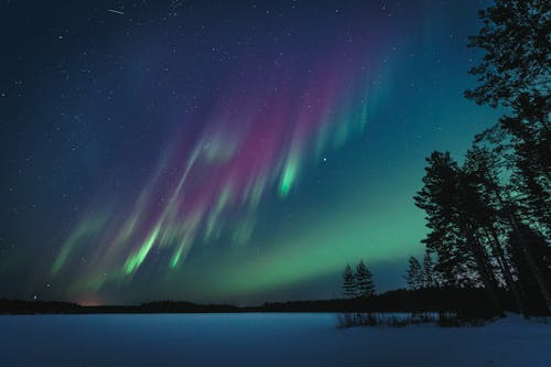 The aurora bore is seen in the sky over a lake