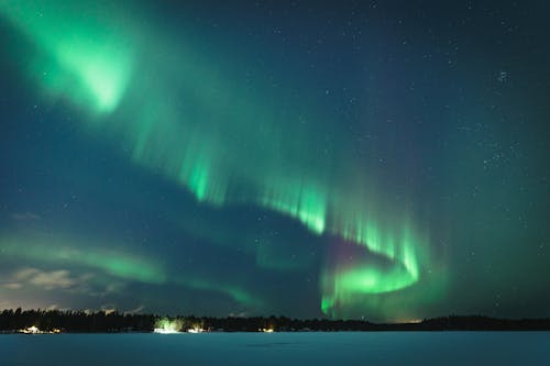 View of Northern Lights over a Snowy Field 