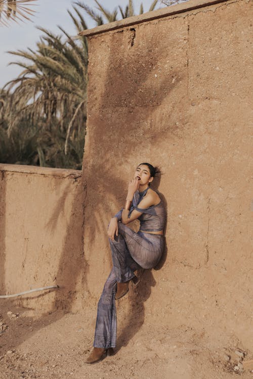 Model Leaning on Sunlit Wall