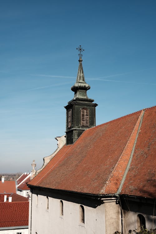 A church with a steeple and a clock on top
