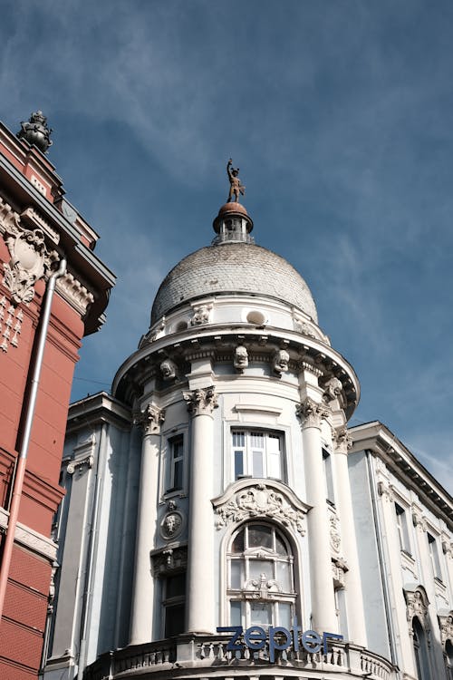 A building with a clock on it and a blue sky