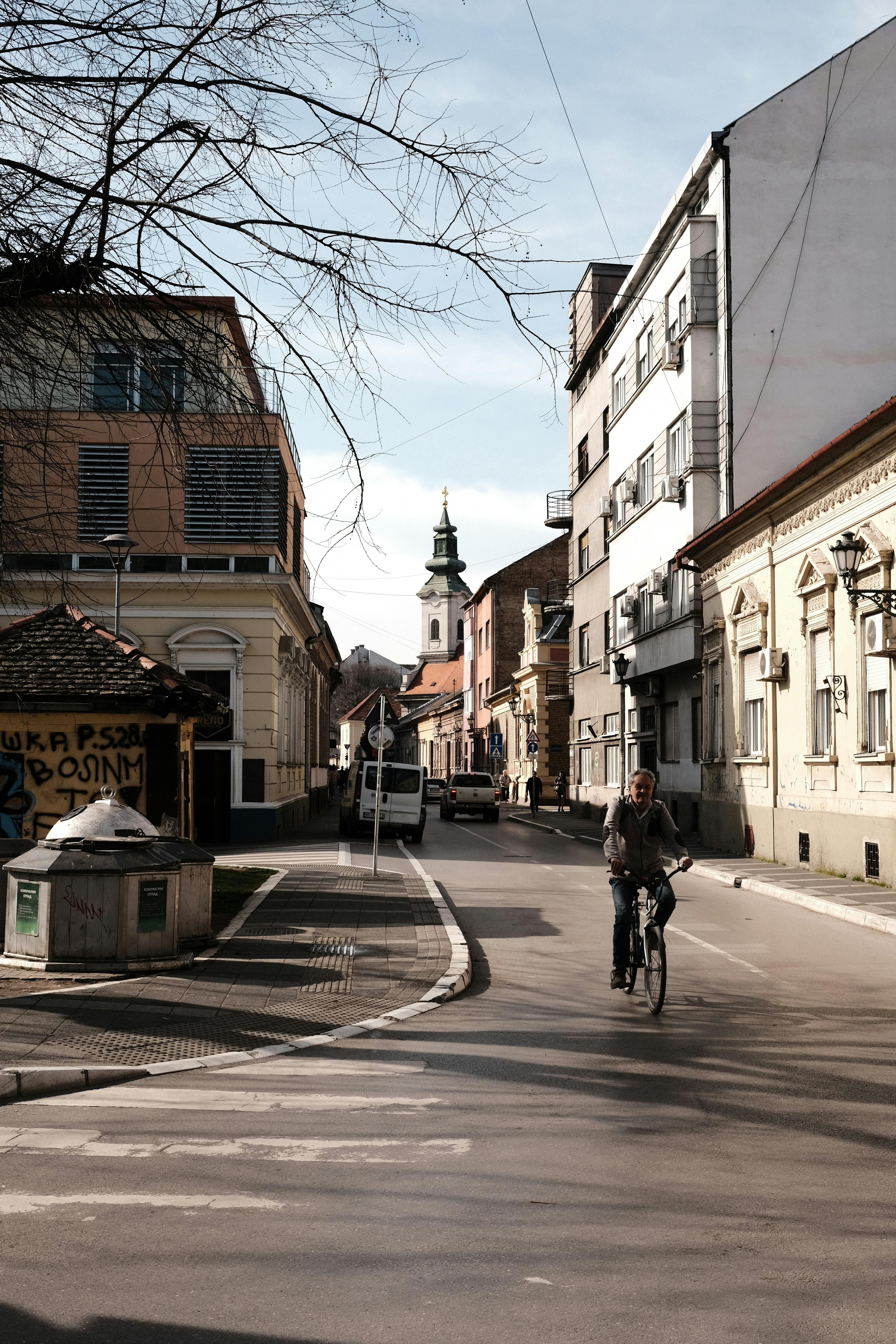 Man Riding Bicycle on Street in Novi Sad · Free Stock Photo