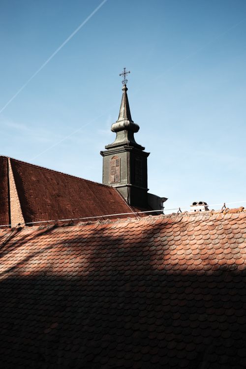 Free A striking Gothic church tower in Novi Sad against a clear blue sky, showcasing architectural beauty. Stock Photo