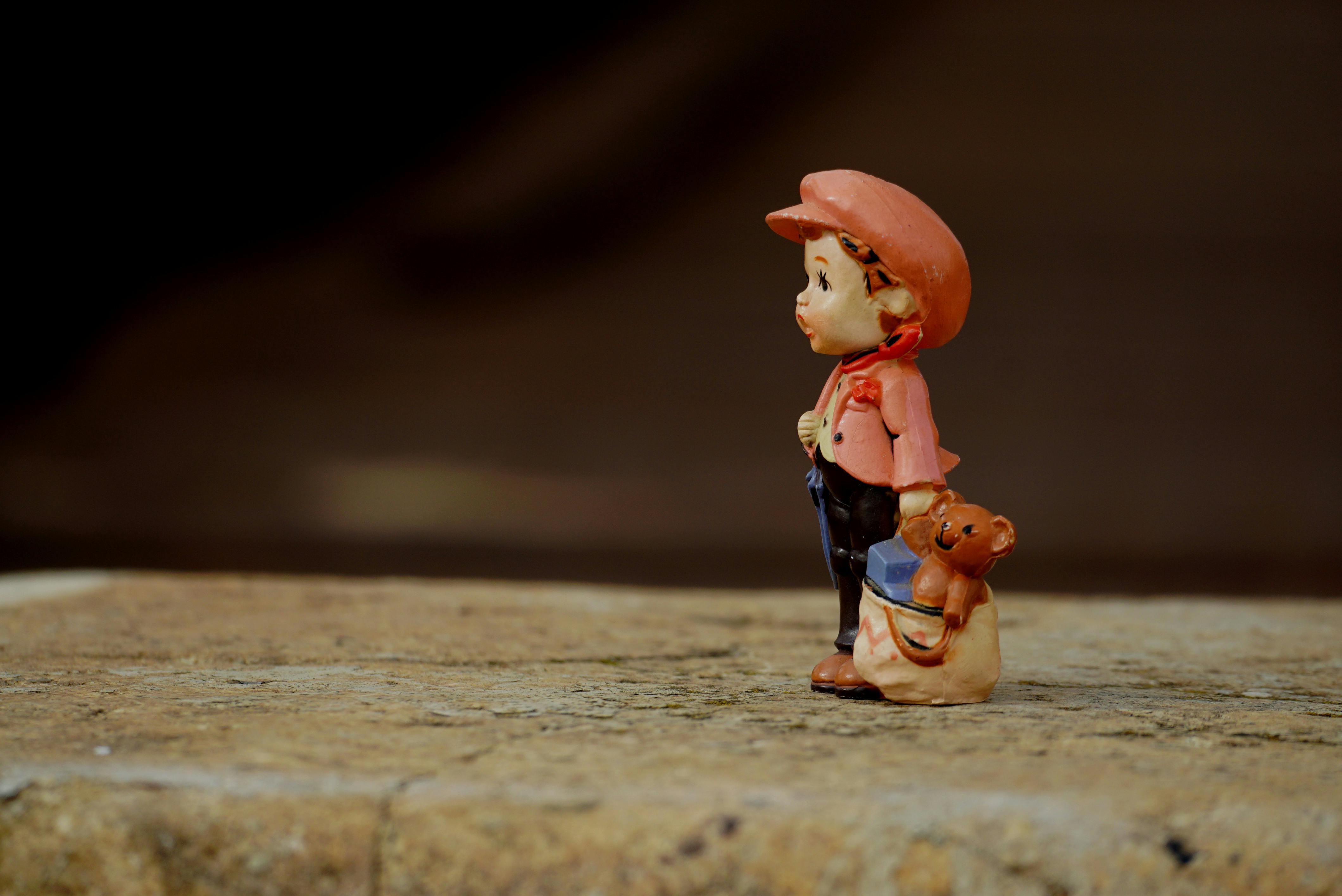 close up of a figurine of a little girl holding a bag of toys