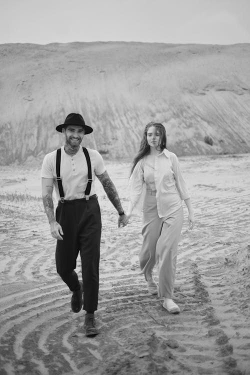 A man and woman walking in the desert
