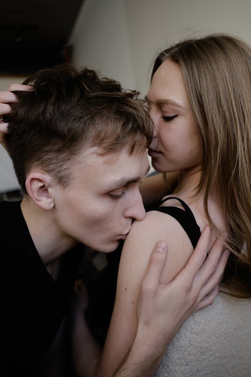 A young man and woman kissing each other