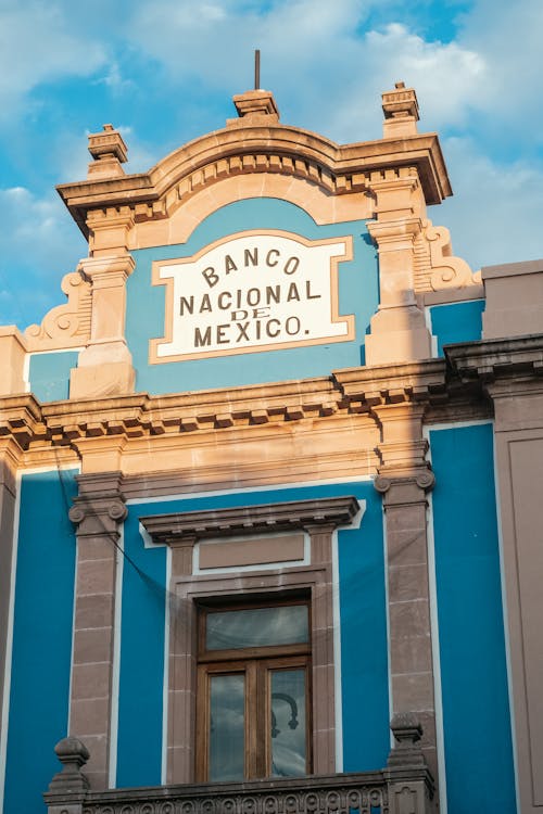 The building is blue and white and has a sign that says the national museum of mexico