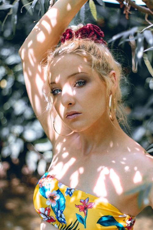 Free Elegant portrait of a woman in a sunny park in Ljubljana, Slovenia. Ideal for fashion and lifestyle projects. Stock Photo