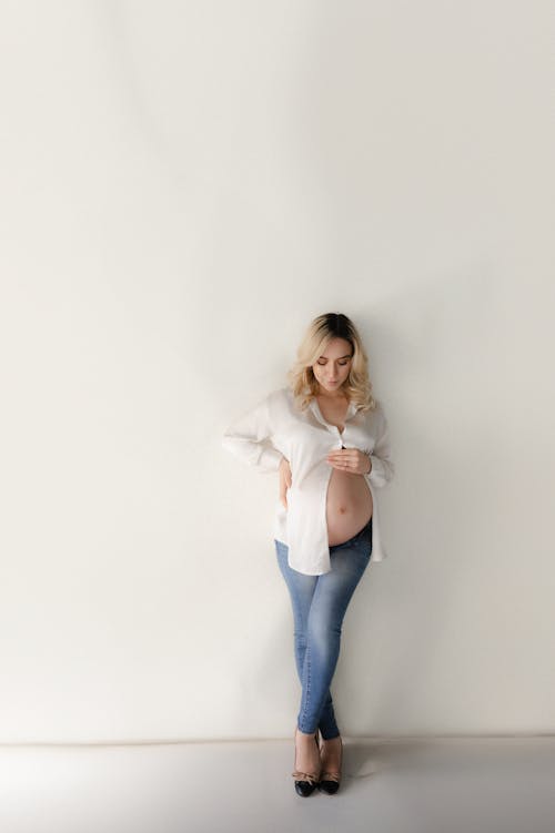 Blonde, Pregnant Woman in White Shirt and Jeans