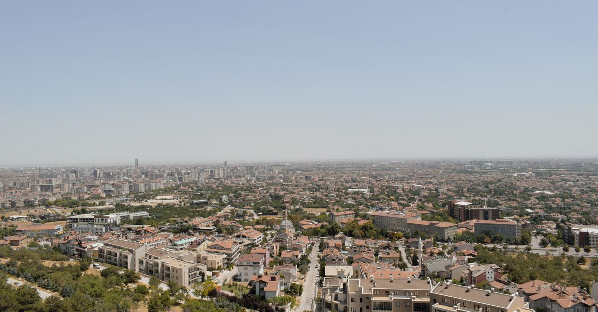 Stunning aerial view of Konya, Türkiye showcasing its urban landscape under a clear sky.