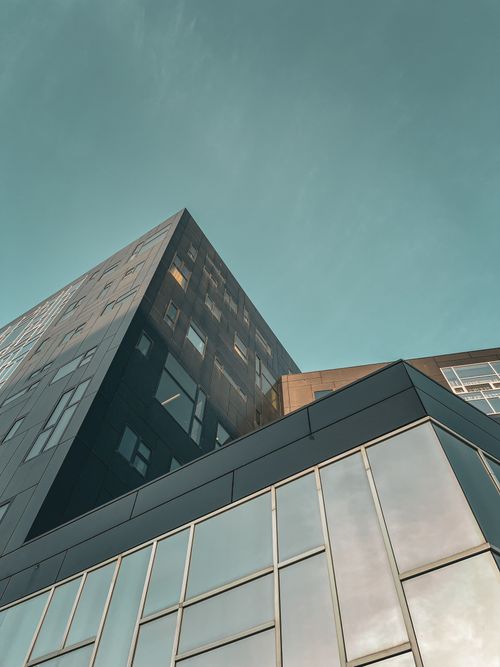 Free Low angle view of a modern office building in Vienna, Austria against a clear sky, showcasing urban architecture. Stock Photo