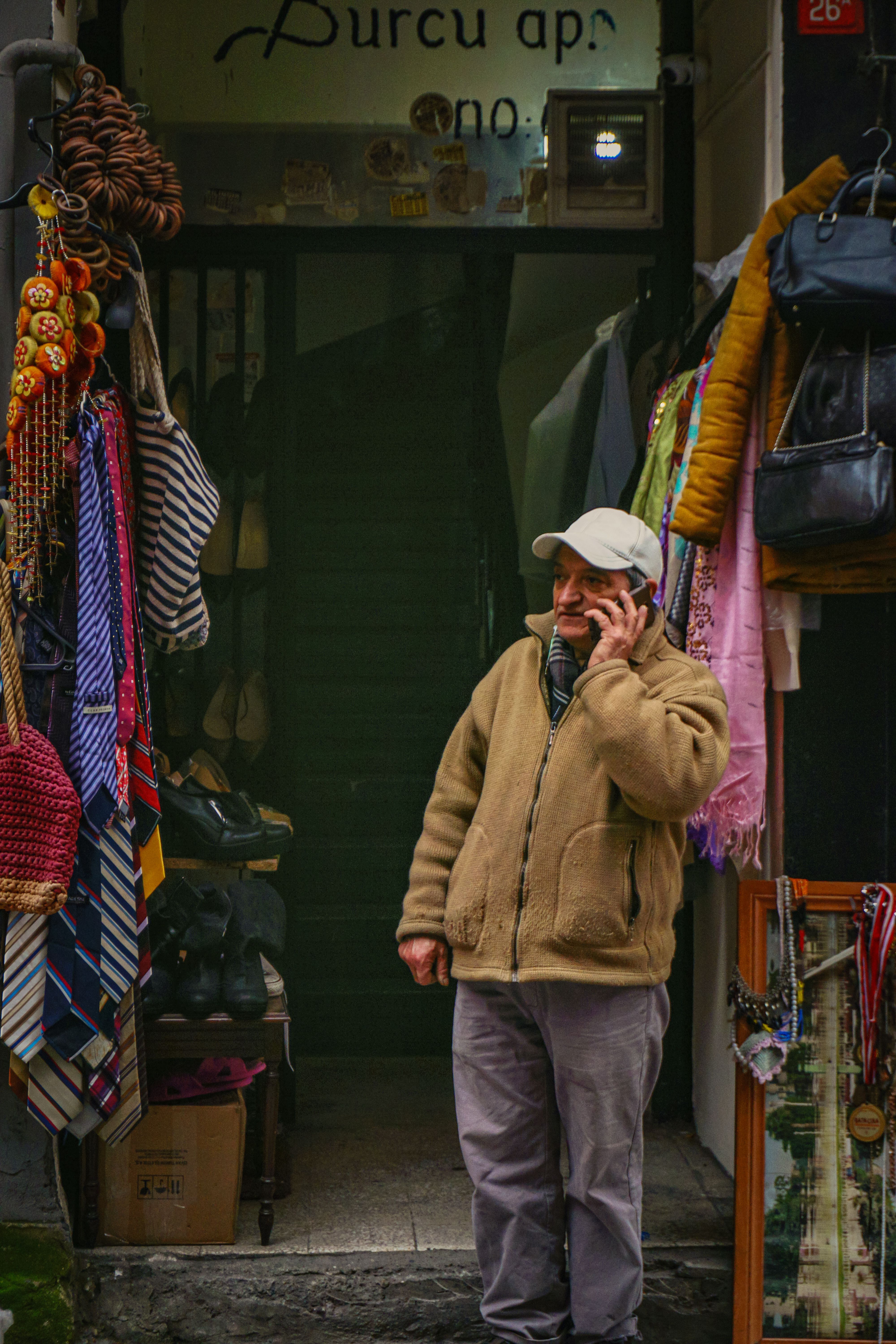 Man Standing in front of a Clothing Store and Talking on the Phone ...