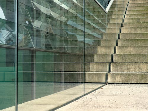 A glass wall with steps and a glass railing