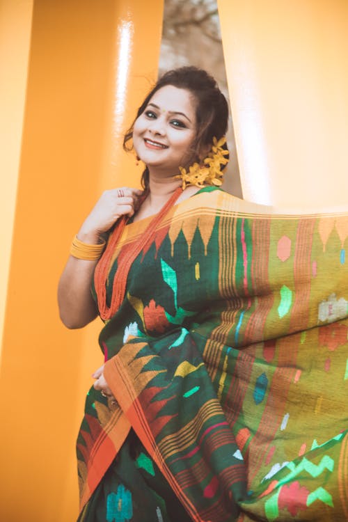 A woman in a colorful sari posing for the camera