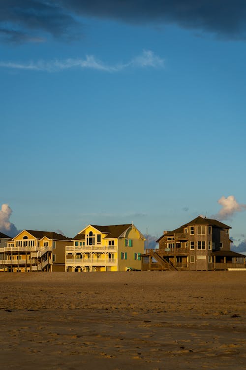 A beach with houses on it at sunset