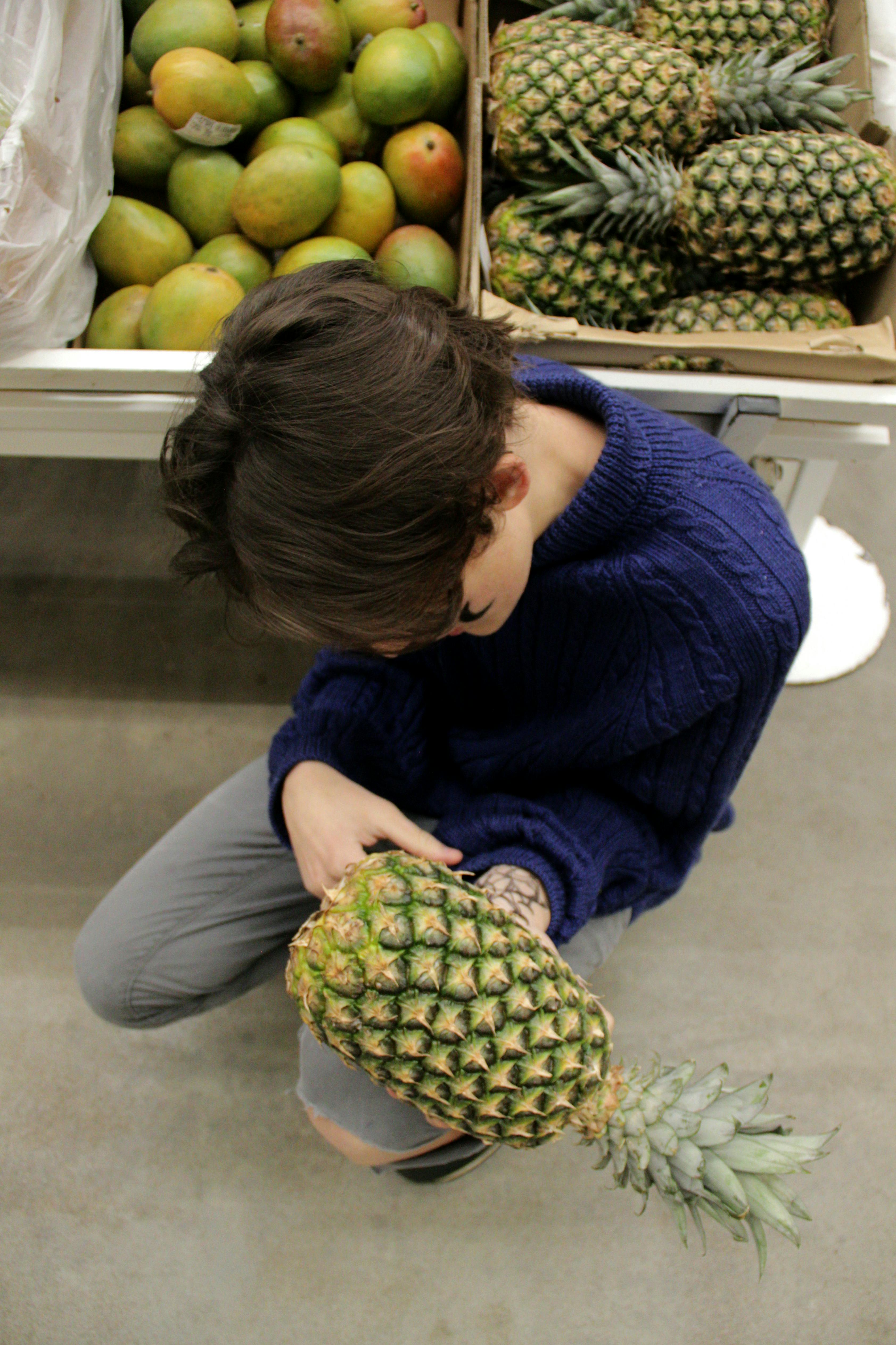 man holding pineapple