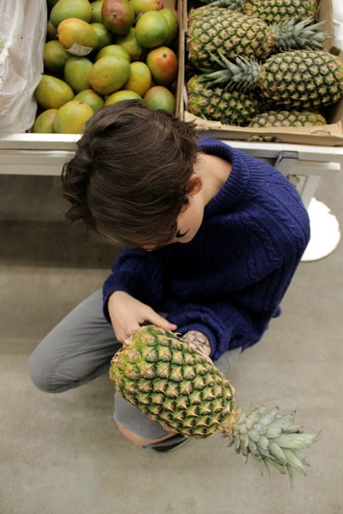 Man Holding Pineapple