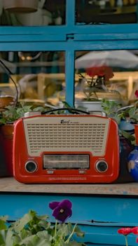 Charming vintage red radio with potted plants creates a nostalgic feel in Üsküdar, İstanbul.