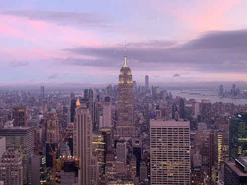 The empire state building is seen at sunset