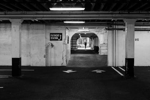 A black and white photo of an empty parking garage