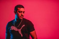 Man Standing Near Red Wall