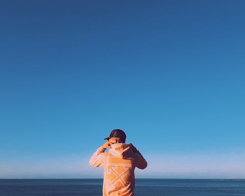 Man Holding His Hood