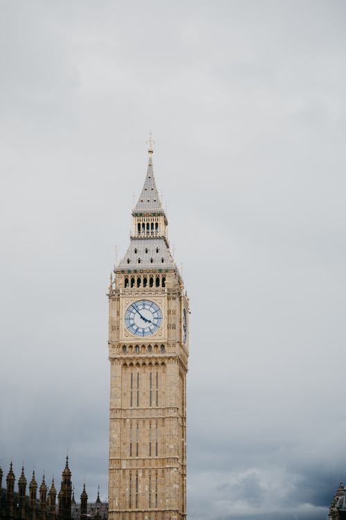 Free Iconic Big Ben clock tower in London under a cloudy sky, a symbol of England. Stock Photo