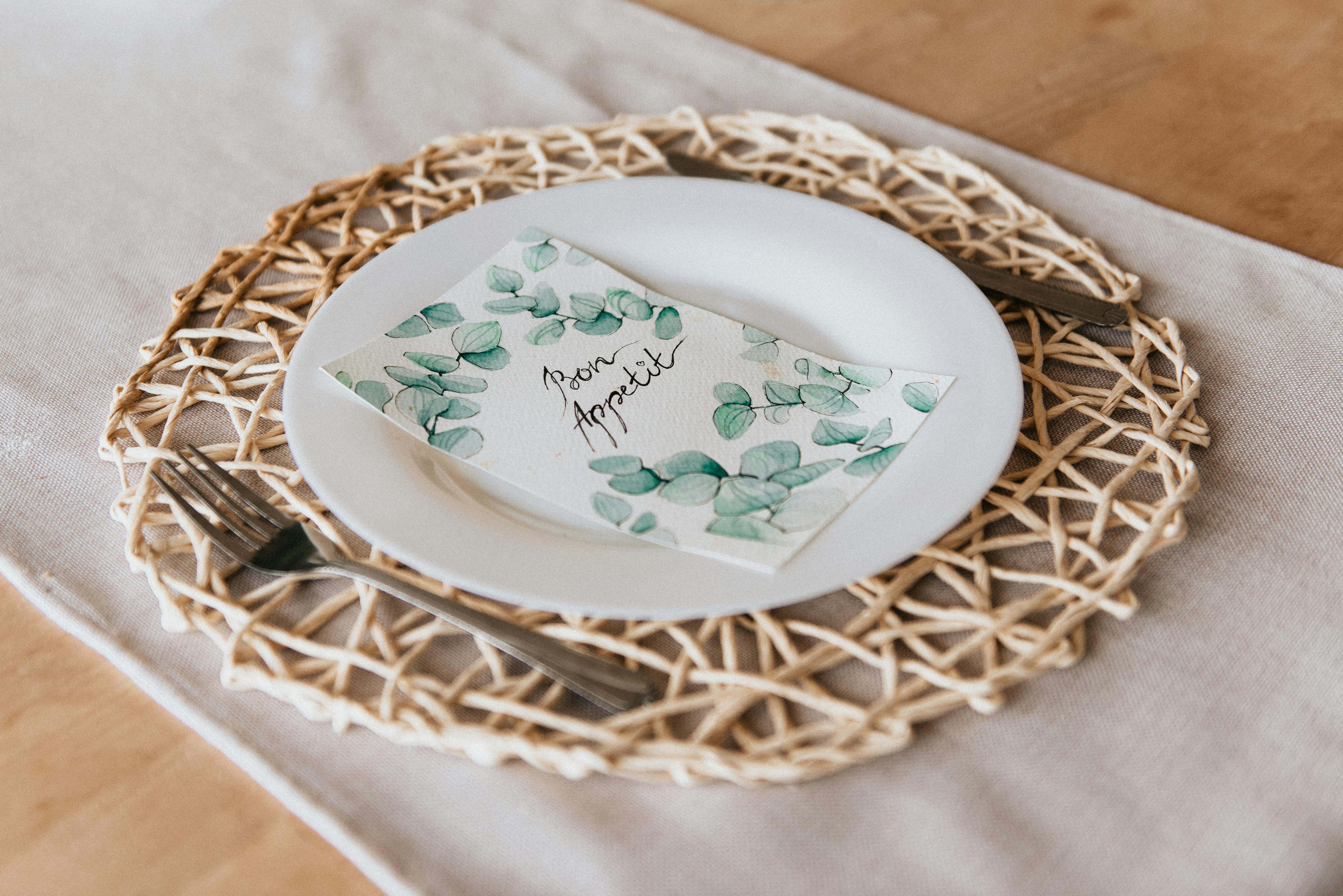 Round White Ceramic Decorative Plate on Brown Mat