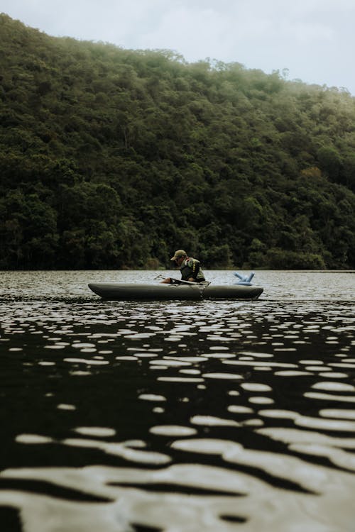 A man in a boat on a lake