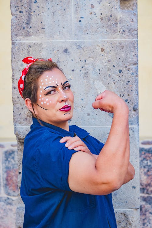 A Woman with Pop Art Makeup Showing Her Biceps 