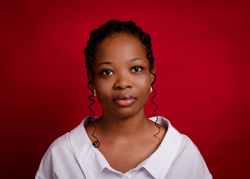 A young woman in a white shirt and red background