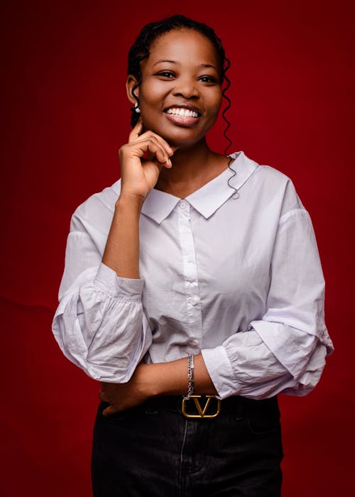 A smiling woman in a white shirt and black pants